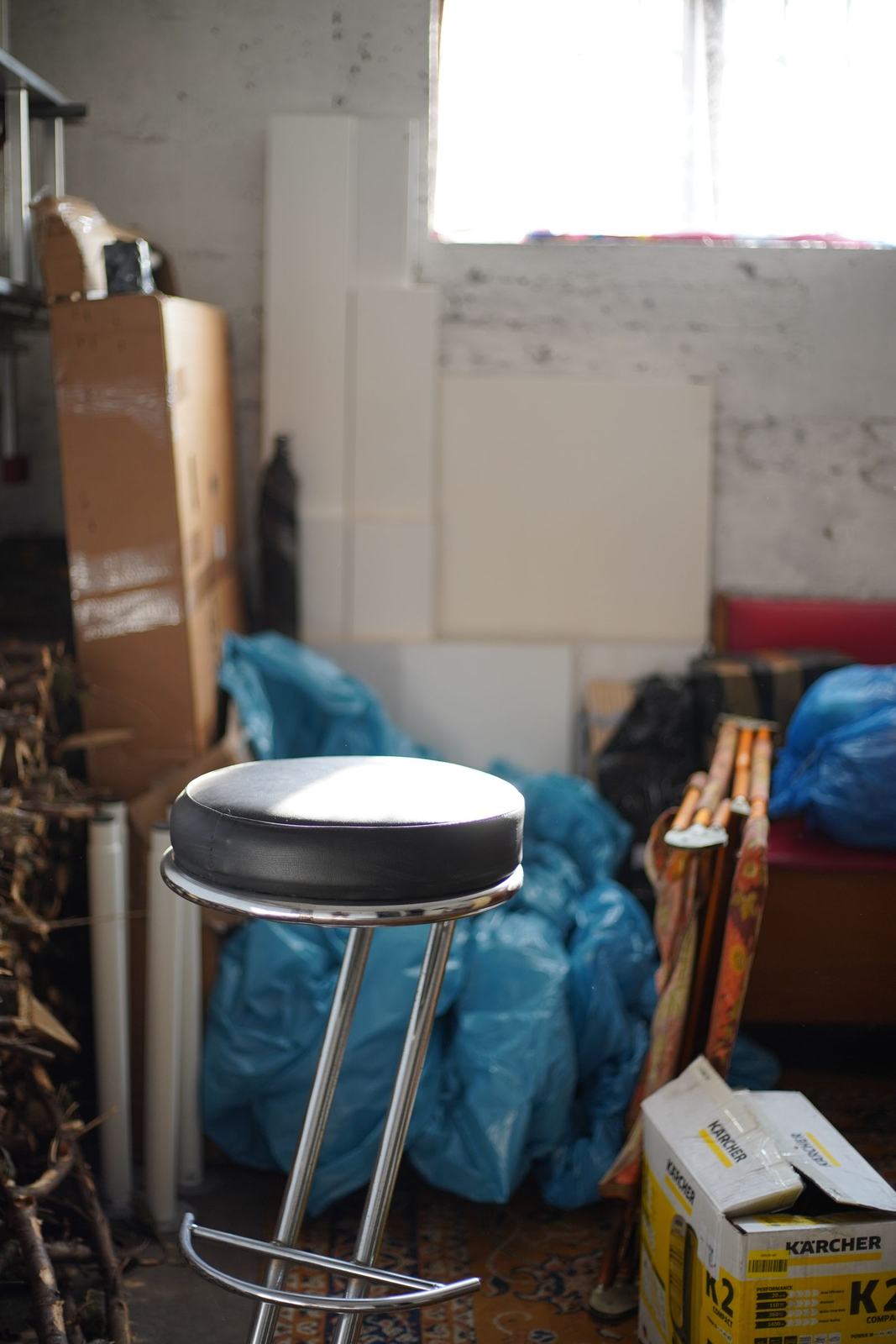 A cluttered basement full of boxes and old furniture ready for a cleanout